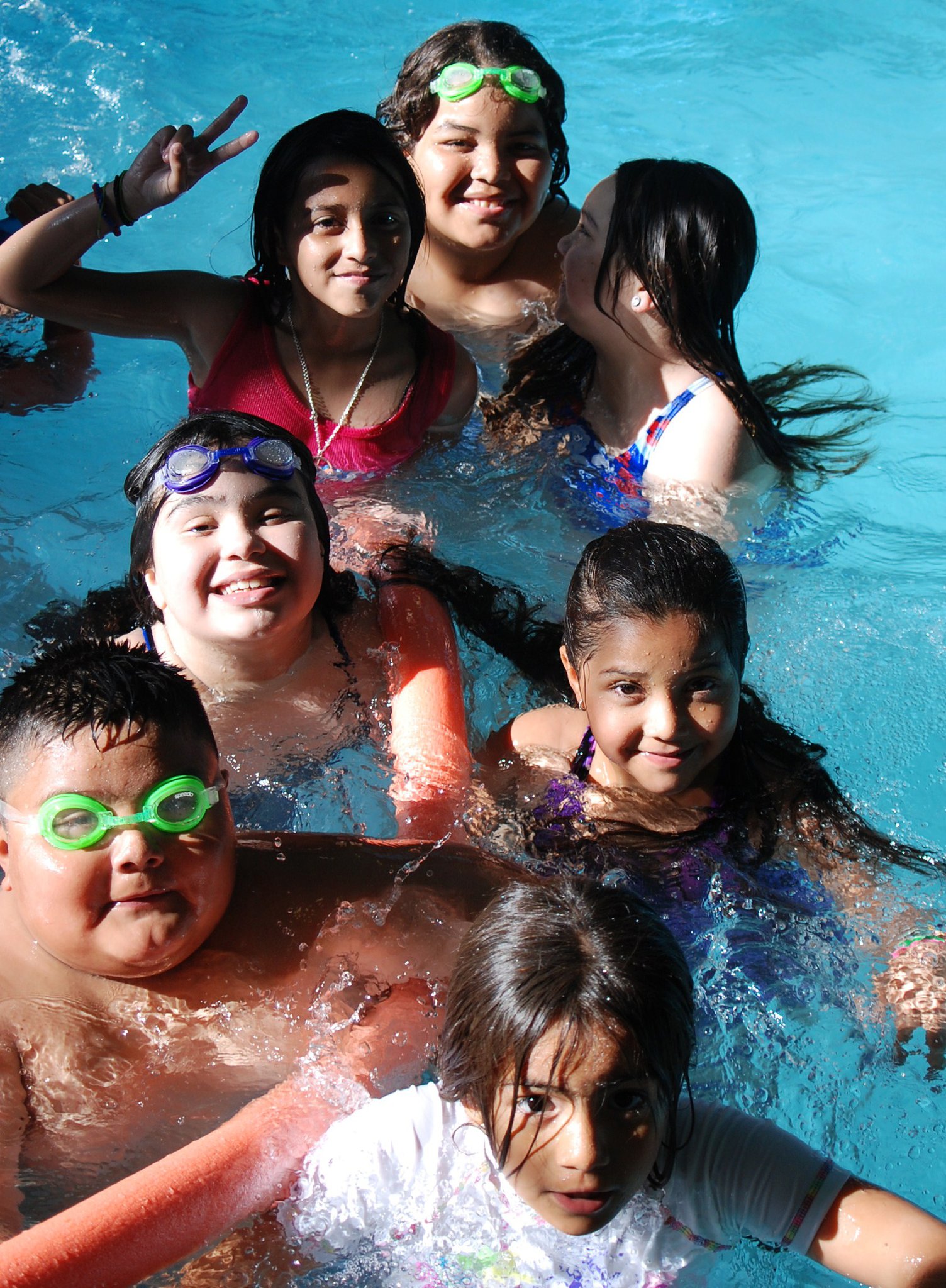 Photo of seven kids in a swimming pool