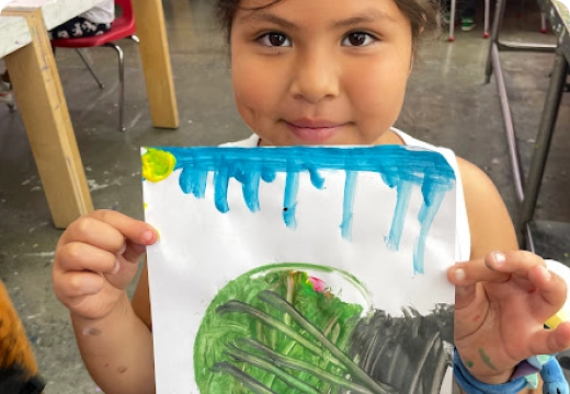 Girl displaying her art at Los Angeles Boys and Girls Club After School Program